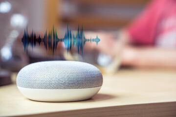 Smart speaker. Male working in background