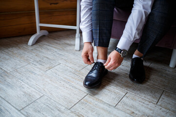 Male businessman puts on stylish shoes. Clothes for men
