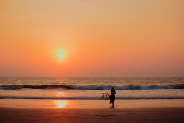 Fototapeta premium Focus on silhouette woman sunset beach holiday vacation lifestyle happiness freedom concept