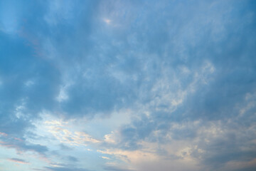 Naklejka na ściany i meble The sky after the storm. Sunlight shines through heavy gray storm clouds.