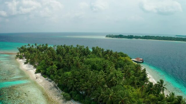 Aerial view of a tropical island in the Indian Ocean. Thinadhoo (Vaavu Atoll), Maldives