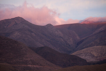 Enchanting altiplano landscape at sunset. View of the Andes mountain range and sky with a beautiful dusk light and color.