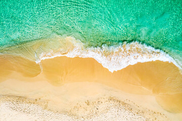 Top view aerial drone photo of ocean seashore with beautiful turquoise water and sea waves....
