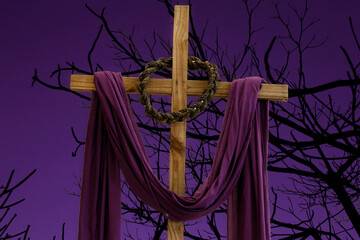 wooden cross, crown of thorns and purple fabric