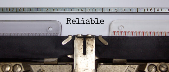 Reliable symbol. The word 'reliable' typed on retro typewriter. Business, reliable concept....