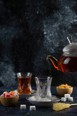 Vertical photo of tea table. Pouring tea to the glass