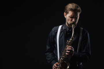 Obraz na płótnie Canvas Man playing jazz on saxophone