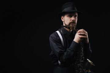 Man holding saxophone in studio