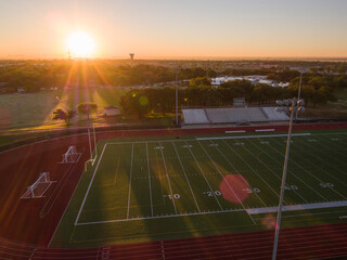 Aerial shot of a high school track and football field in Texas at sunrise