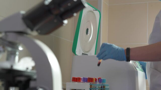 Doctor conducts a blood test in a medical laboratory.