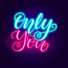 Only you. Glowing pink neon incription on dark brick wall background.
