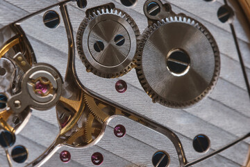 Fototapeta na wymiar Close-up of the internal clockwork. Selective focus. Macro photography. Gear movement. Time tracking. High quality photo