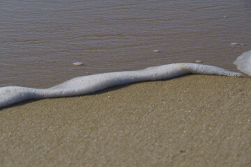 Sand and sea water at Piratininga Beach, Niterói in Rio de Janeiro. Sunny day.