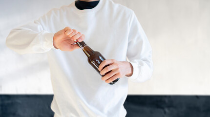 man open the glass beer bottle on party, bad habit, alcohol addict