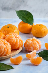 Vertical photo of peeled and whole mandarins