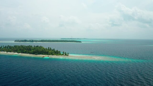 Aerial view of a tropical island in the Indian Ocean. Thinadhoo (Vaavu Atoll), Maldives