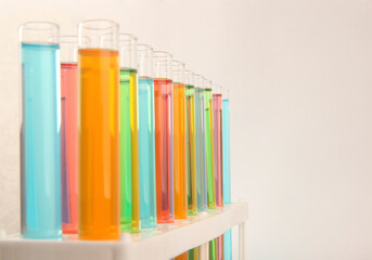Lines of test tubes arranged in rows with red and blue solution inside in a laboratory for medical...