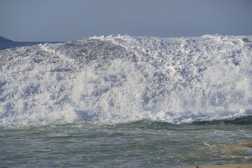 Waves crashing in the sea at Piratininga Beach, Niterói in Rio de Janeiro. Sunny day.