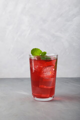 Red summer non-alcoholic refreshing drink with ice or fruit iced tea, close-up