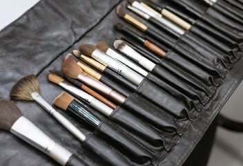 set of makeup brushes in a black case, a concept of a make-up and a visit to a beauty salon