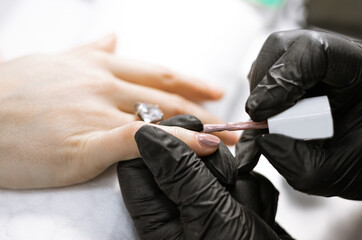Fototapeta premium manicure in a beauty salon the process of nail polish coating