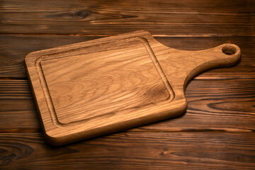 vintage cutting board with space for text on old wooden background, close-up