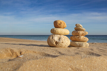 pile of pebbles on a sandy beach, balance, zen concept