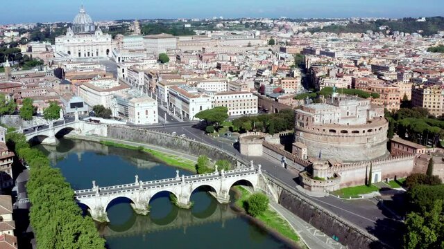 Aerial view of downtown Rome, Italy. City center with Mausoleum of Hadrian or Castel Sant'Angelo seen from drone flying in sky and Saint Peter's Basilica in Vatican City in background