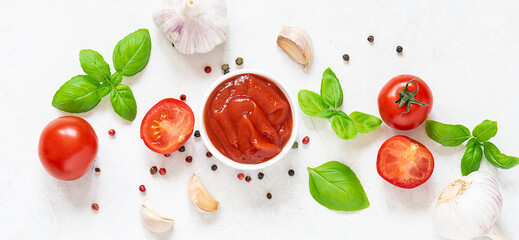 Long wide banner with homemade tomato sauce with fresh aromatic basil, cherry tomatoes, peppercorn and garlic on white marble background. Culinary blog banner concept.