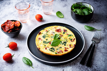 Spinach Dried tomatoes Frittata in a plate