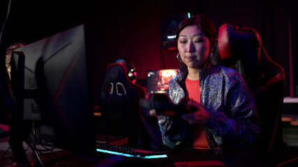 Frustrated girl gamer loses the game, removes the headset and leaves the playing area