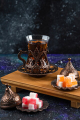 Vertical photo of colorful candies and fragrant tea