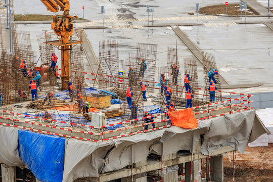 Bar bender fixing steel reinforcement for house concrete floor slab. construction worker Concrete pouring during commercial concreting floors of building in site and Civil Engineer.