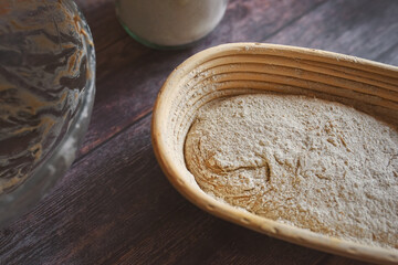 A close up view of a basket with sourdough bread before leavening and baking.