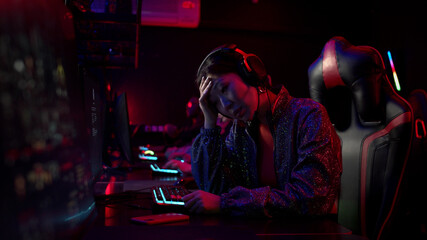 The chinese gamer girl decided to take a break and play on her smartphone, she is tired, losing and upset © iaginzburg