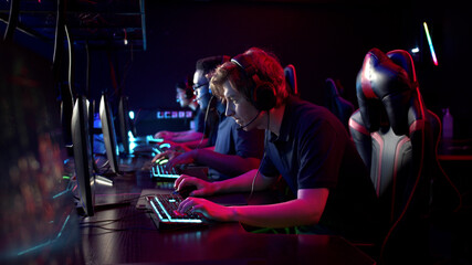 Professional esports players at an online game tournament. The cyber team plays computers and trains