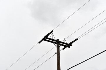 A low angle shot of overhead power line under the clear sky