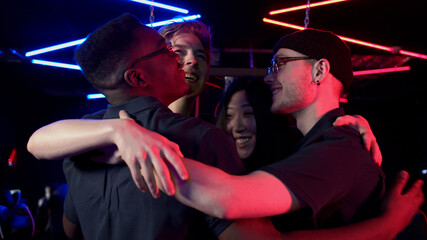 Multi-racial team of esports players tune in to the game and embrace for team spirit boost, slow motion © iaginzburg