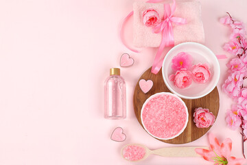 Spa and wellness composition with aromatic rose water, salt, roses and sakura, towels, aromatherapy and skin care, lifestyle concept, invitation and advertising card, selective focus