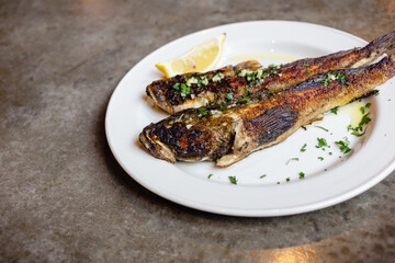 fried goby fish on plate, close-up