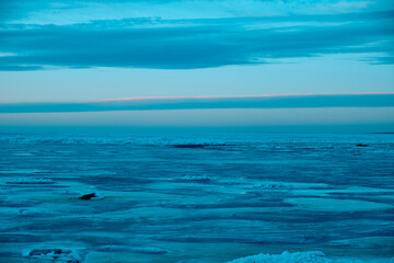 icy beach on the background of the sunset