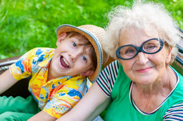 Heppy Grandmother and her grandson face to face in embrace. Emotional portrait closeup. Family...