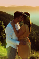 Beautiful couple walking on the mountain during sunset.