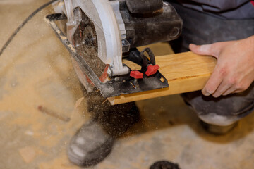 Close Up process cutting of hand circular saw at wood beam cuts