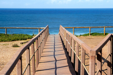 Wooden footbridge on the way to a beach in Algarve Portugal.