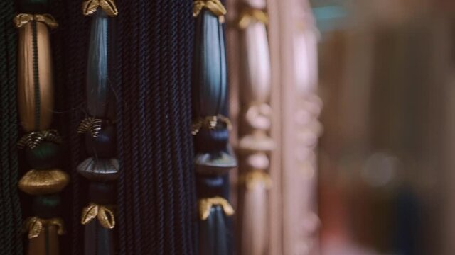 closeup of luxury tieback tassel curtain accessory with fringe at textile store