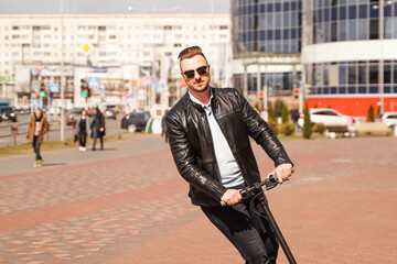 Modern man riding electric scooter in the city