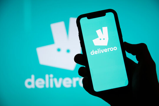 LONDON, UK - April 2021: Deliveroo takeaway delivery service logo on a phone