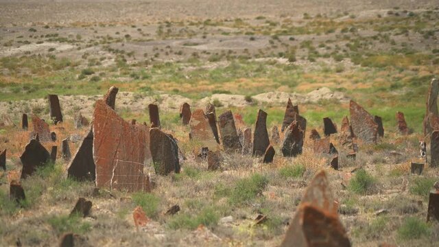 Tombstones and obelisks in the prehistoric cemetery.Anthropomorphic kurgan stone stelae statue menhirs steles ancient monument.Menhir orthostat lith old bronze age megalith Stele mass graveyard grave 