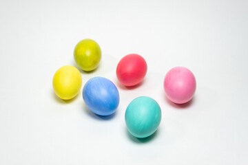 Six colorful eggs on white background. Selective focus. Creative Easter background